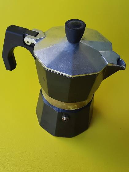 a coffee pot on a pea-green table